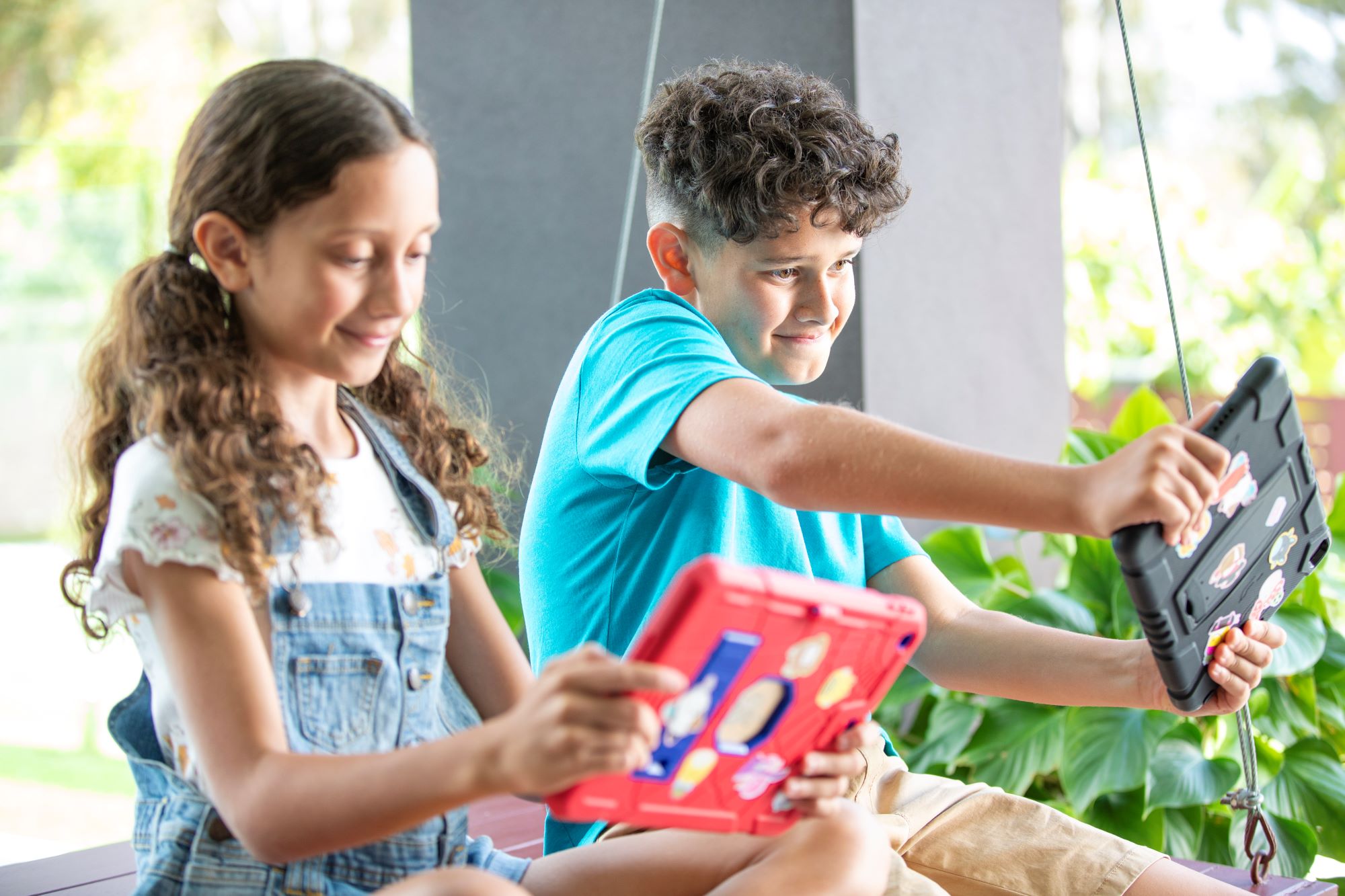 Two children playing on ipads