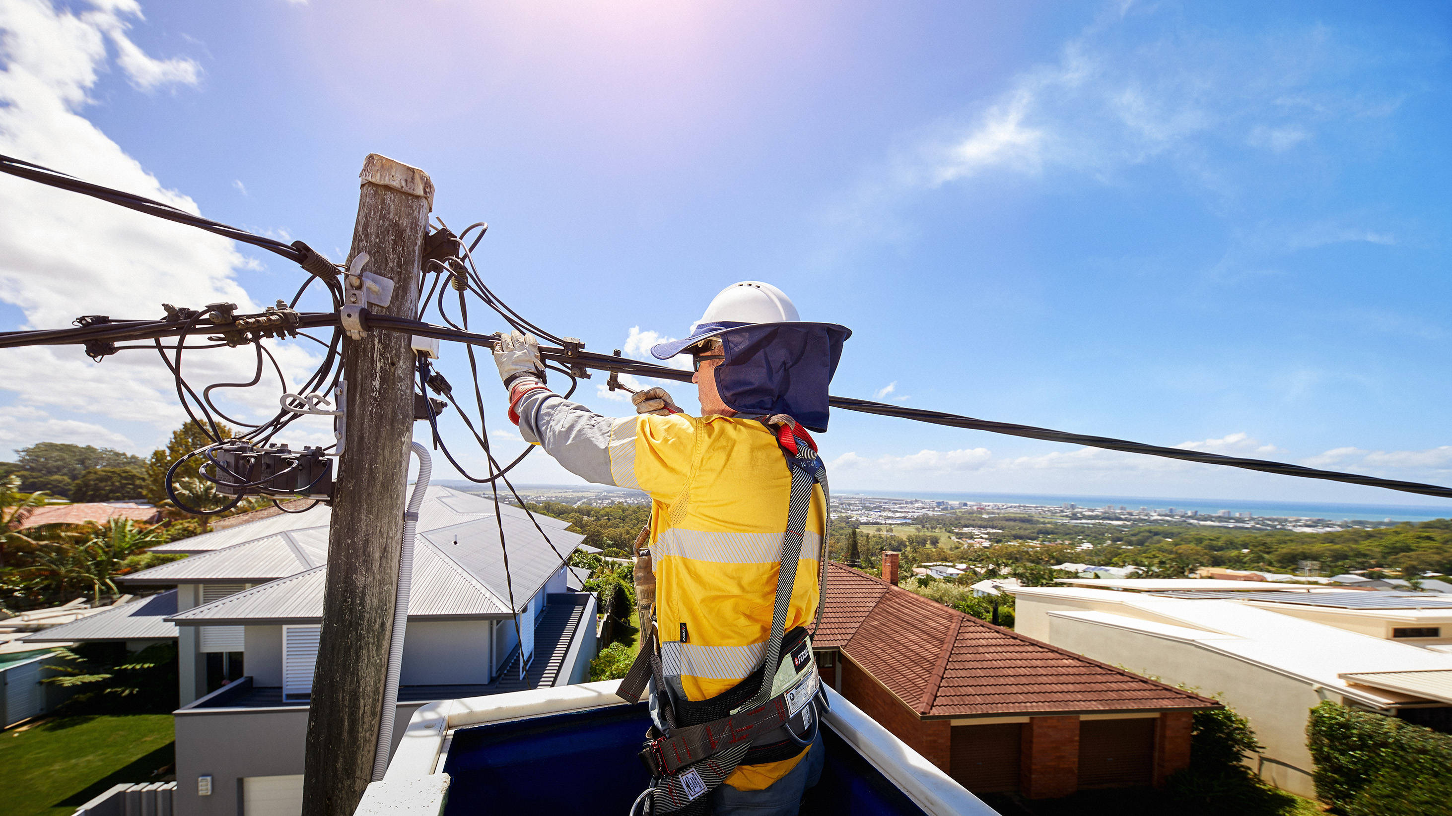 Man working on powerlines from EWP