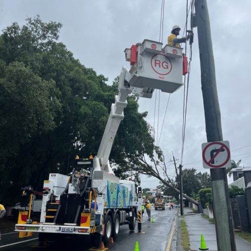 Employee in cherry picker working on powerlines