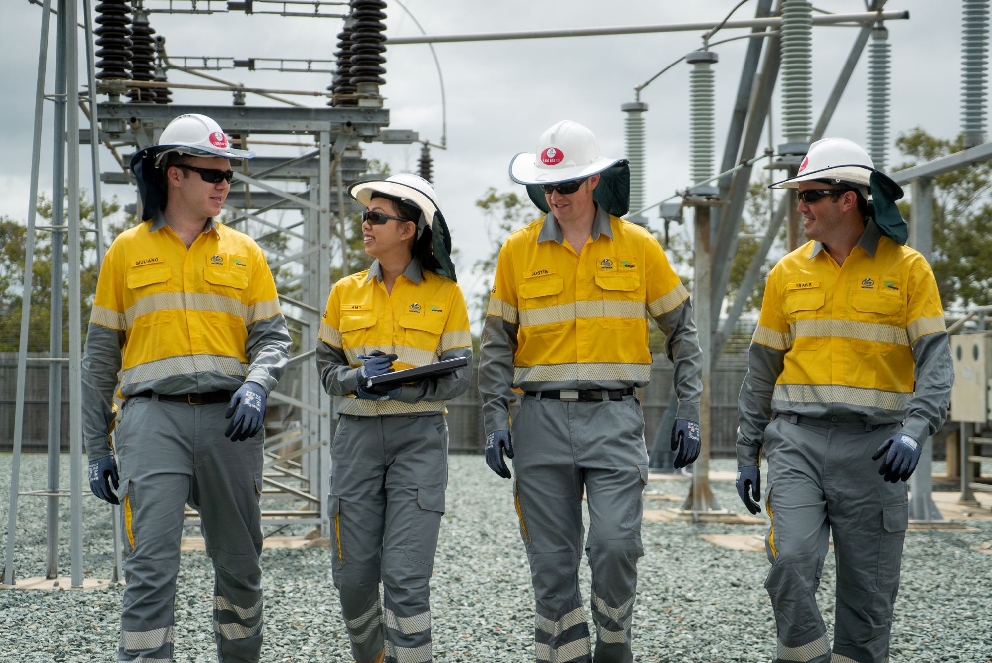Four apprentices walking through substation together