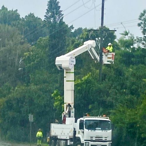 Field crew in cherry picker working on powerlines