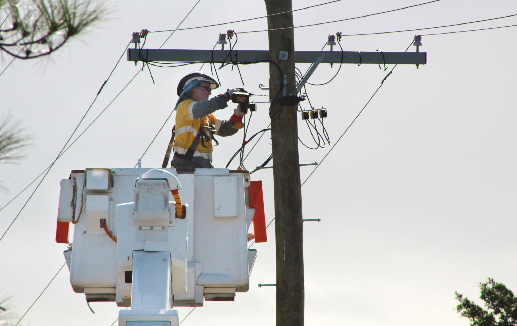 Field crew working on powerlines in cherry picker