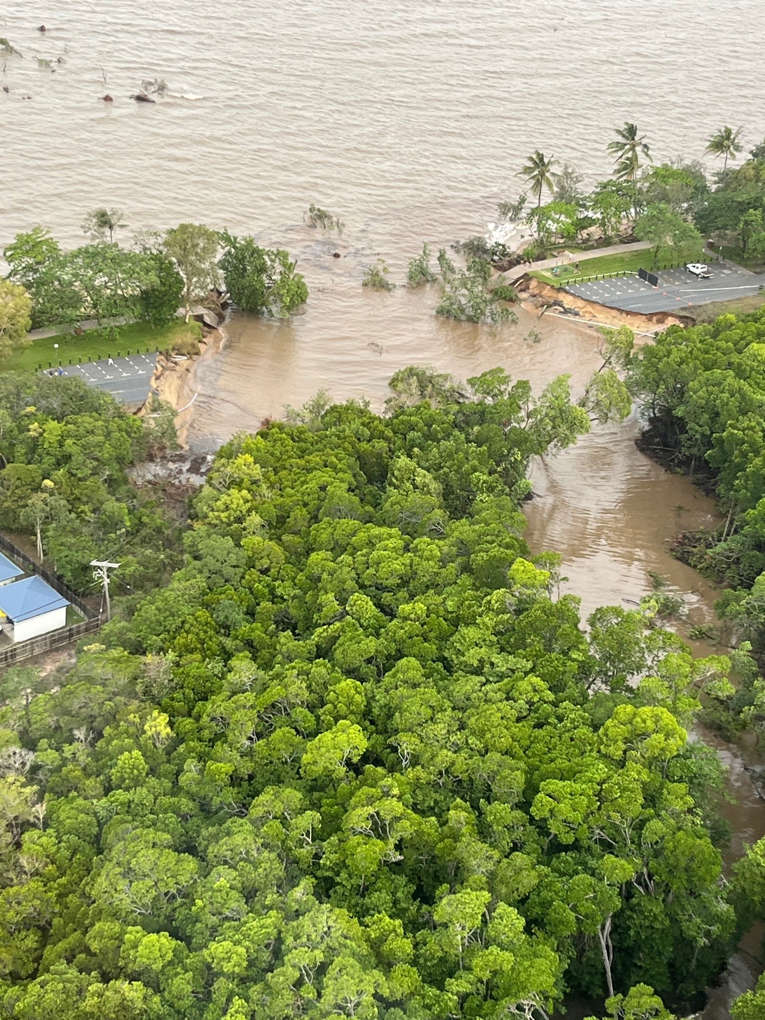 Aerial view of Holloways Beach road washed away by floods.