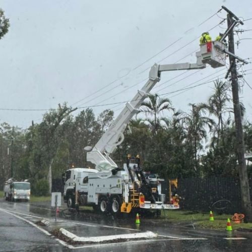 Crews in cherry picker working on powerlines